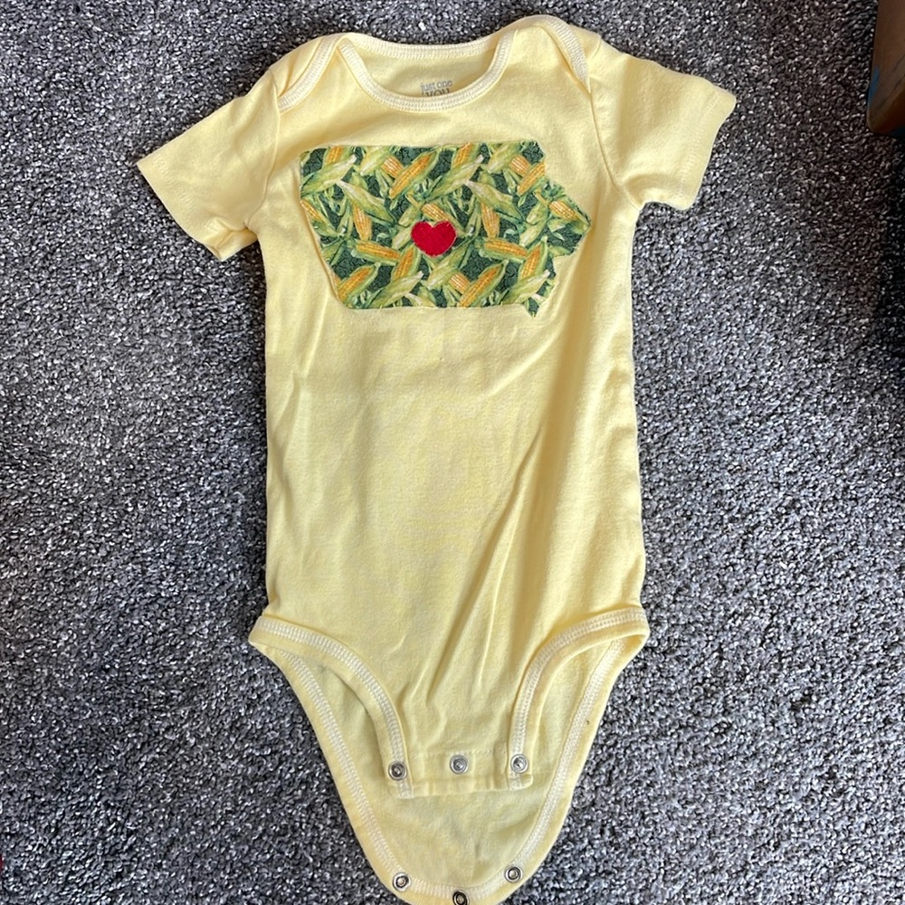 onesie with hand sewn Iowa cut out with corn print and red heart